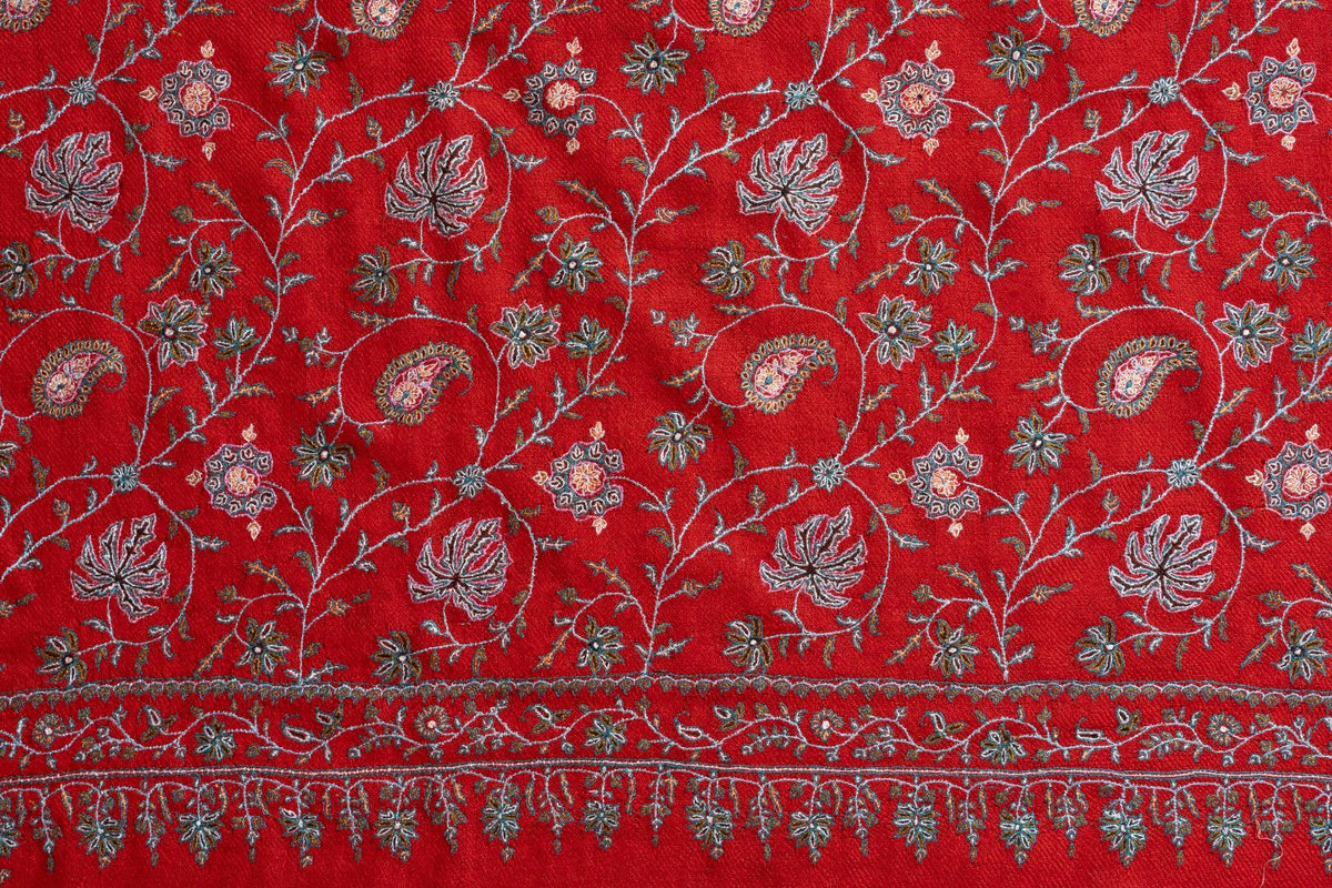 Scarlet shawl end with pale Sozni paisleys, flowers and leafy vines above a narrow border with pendant motifs