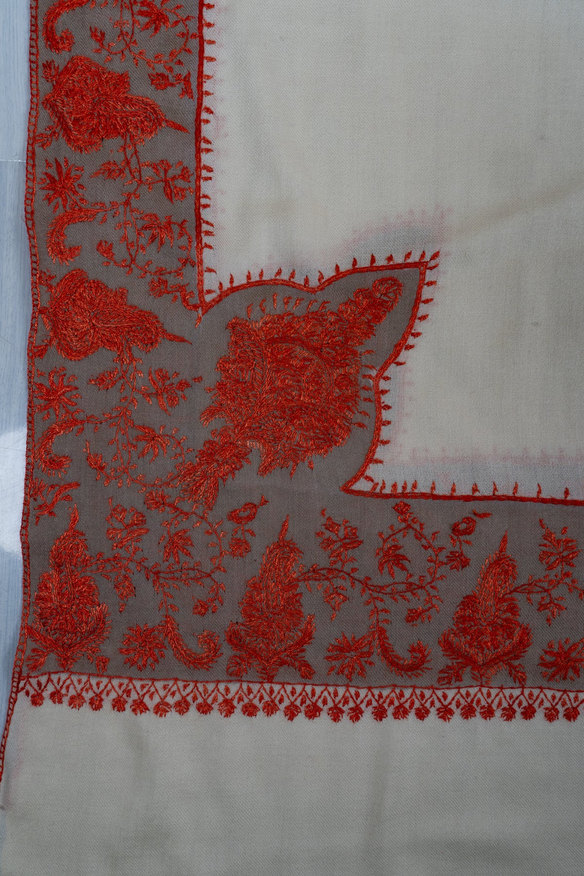 Ivory shawl corner with a large red floral motif rising from a broad Sozni border on a pale grey band