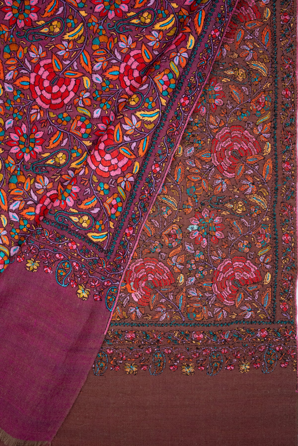 Plum Pashmina shawl folded back to show colourful floral embroidery on the front and the muted brown reverse
