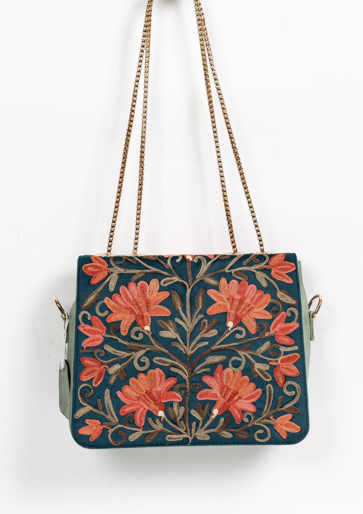 Teal floral chain bag hanging from gold-toned straps, with coral Aari flowers and symmetrical brown leafy vines