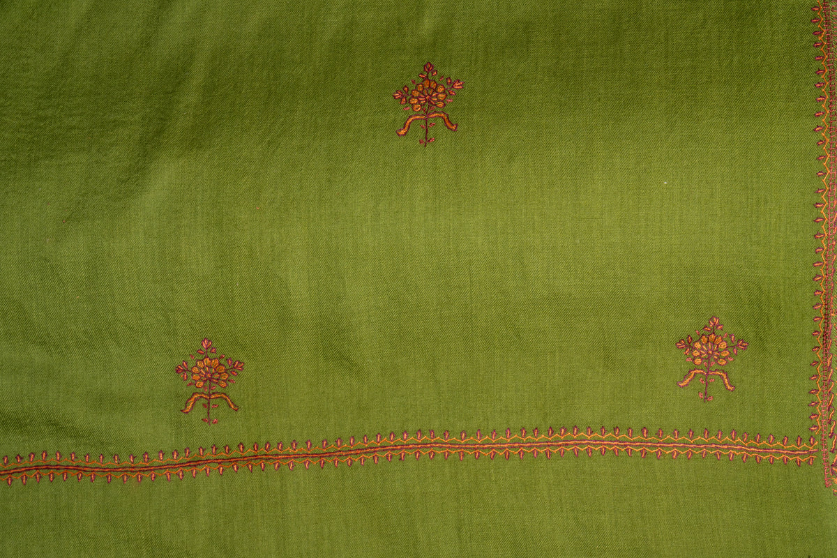Green Merino wool stole laid flat with spaced red and orange Sozni floral sprigs above a fine embroidered border