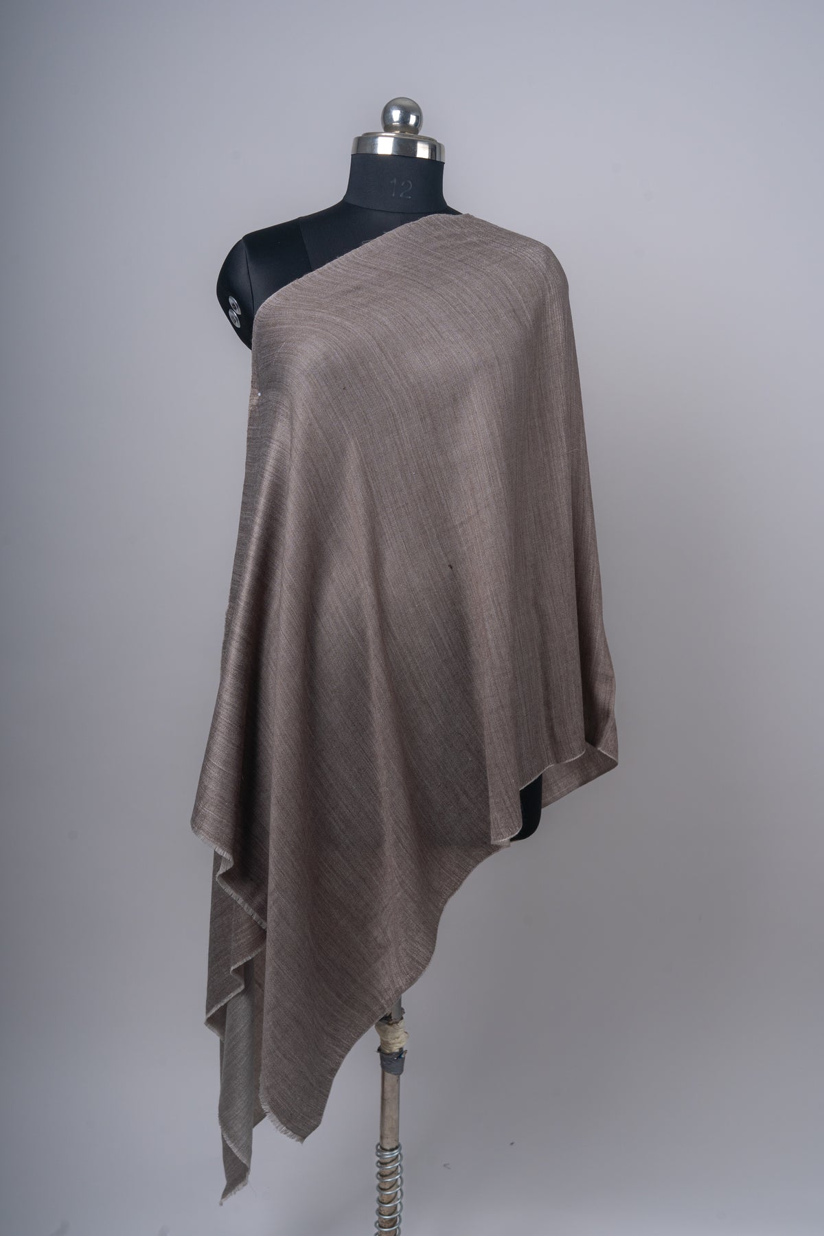 Mocha side of the plain reversible stole draped diagonally over a mannequin, showing its long uneven folds.