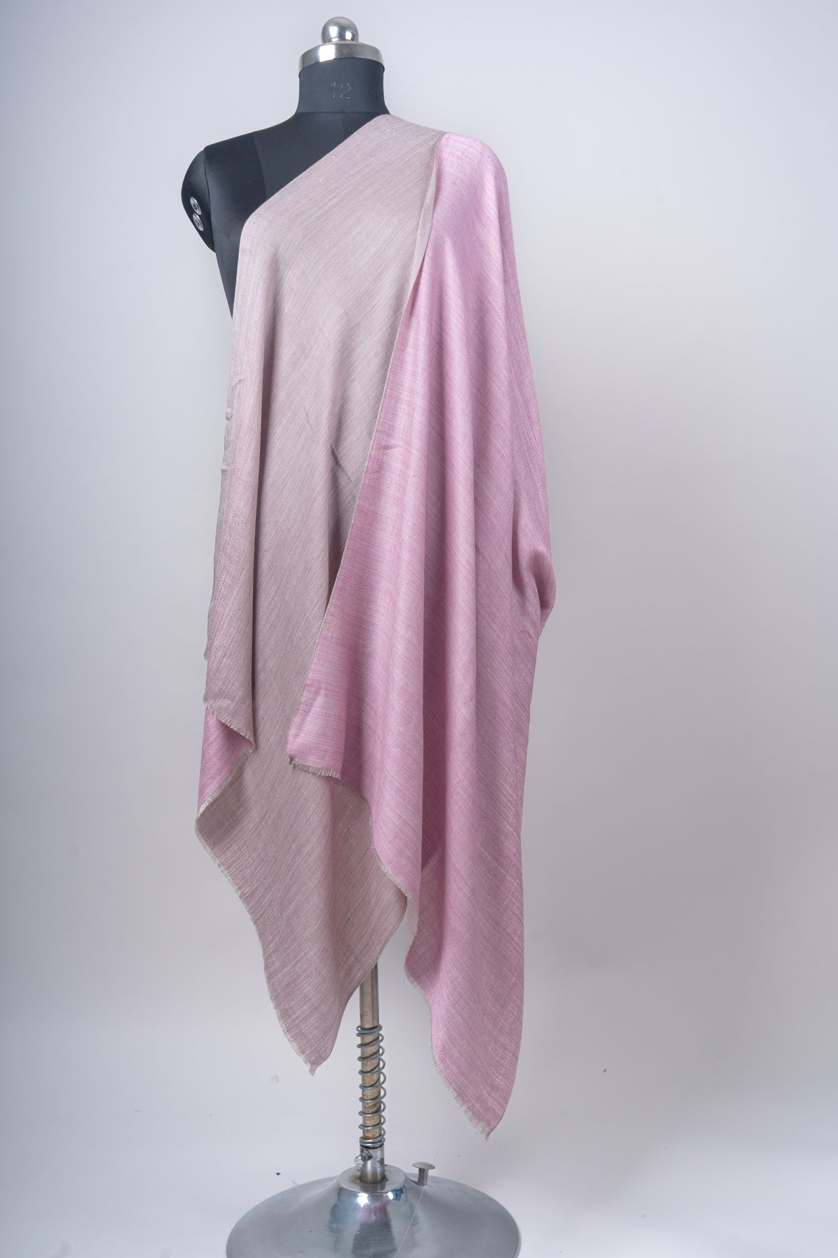 Reversible Merino wool stole draped on a mannequin to show the rose-pink and mauve-grey sides together