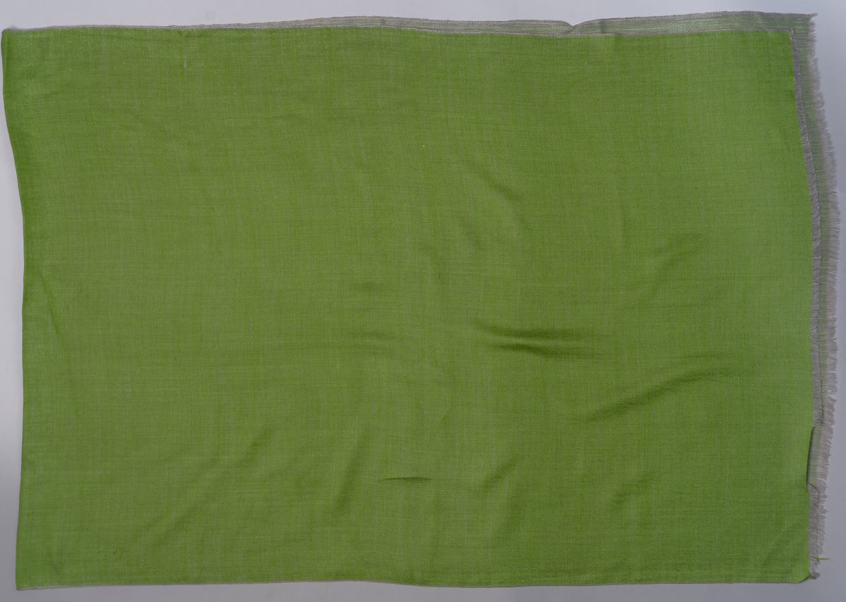 Green side of a rectangular reversible Merino wool stole laid flat, with a narrow grey edge underneath