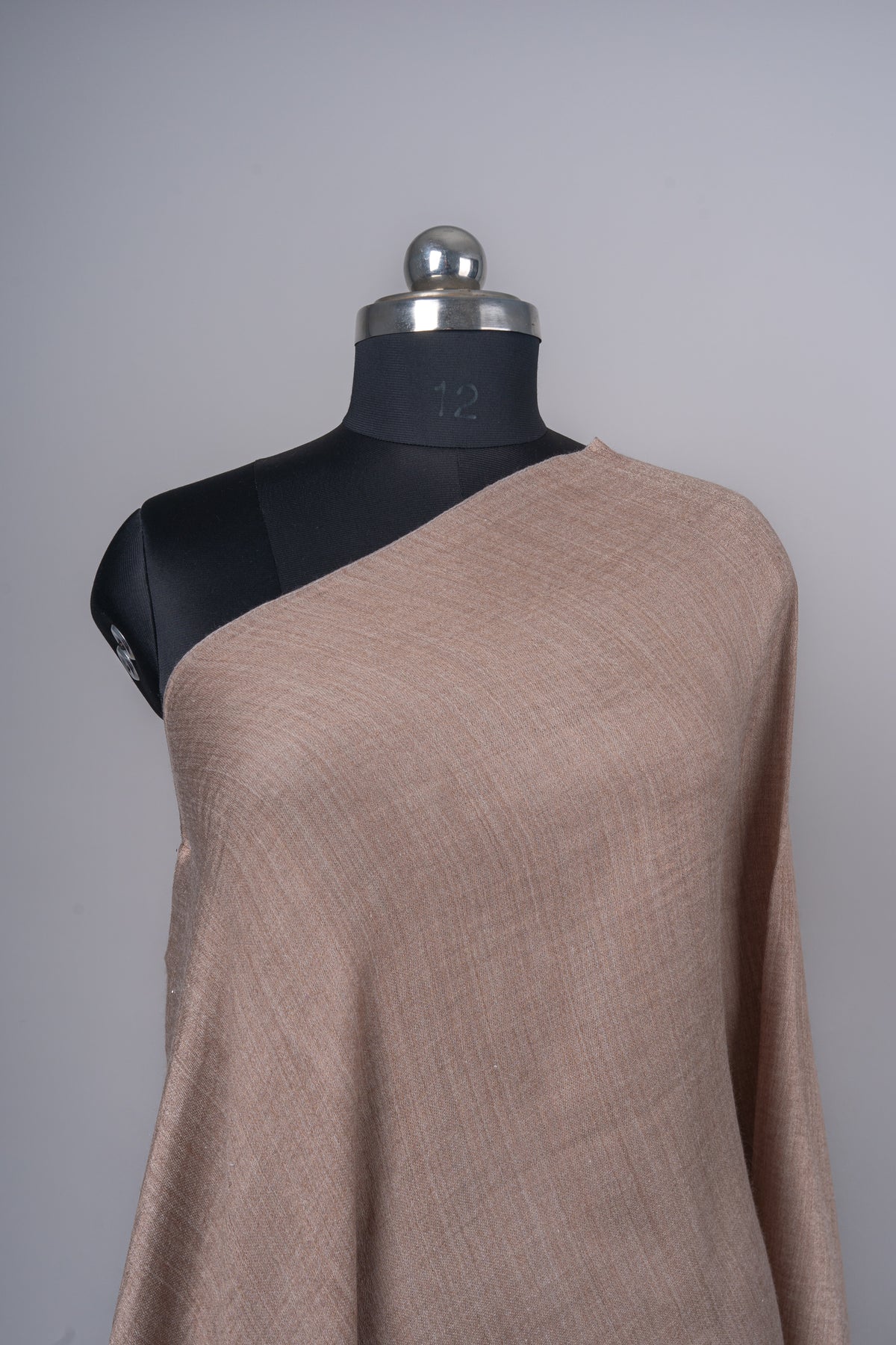 Close-up of the almond-beige stole shoulder, showing a fine crosshatched weave and plain edge.