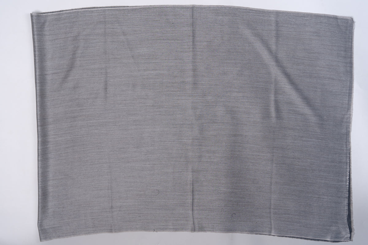 Slate-grey side of the reversible stole laid flat, with a narrow charcoal edge showing beneath
