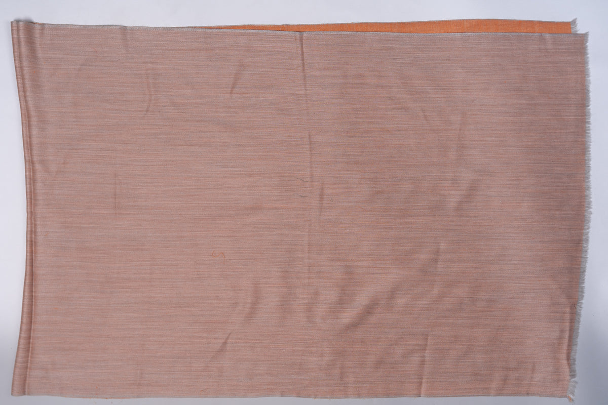 Sandstone-beige side of a rectangular reversible stole laid flat, with an amber strip visible along the top edge