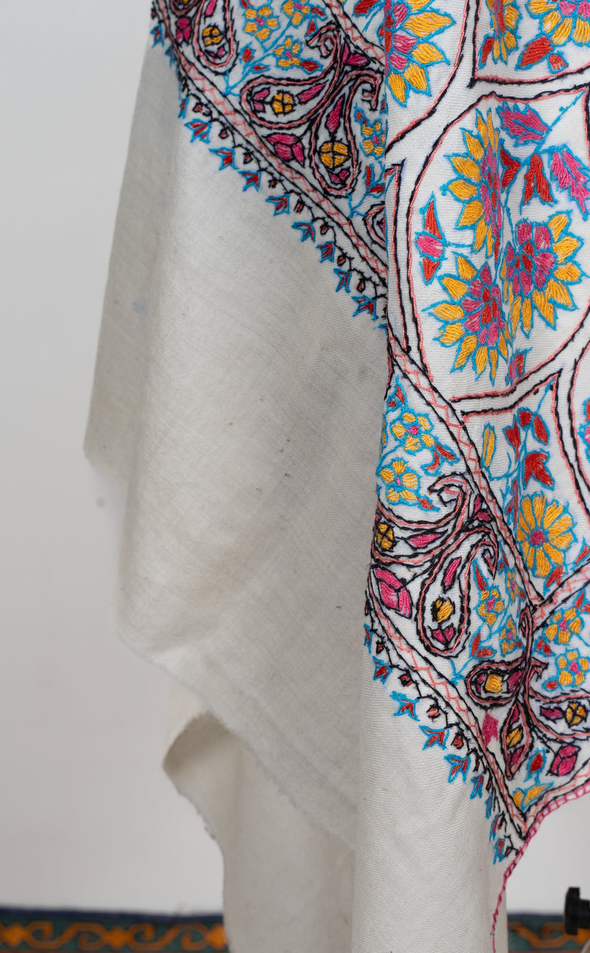 Hanging end of an ivory stole with colourful Sozni floral lattice embroidery, a paisley border and a plain ivory band