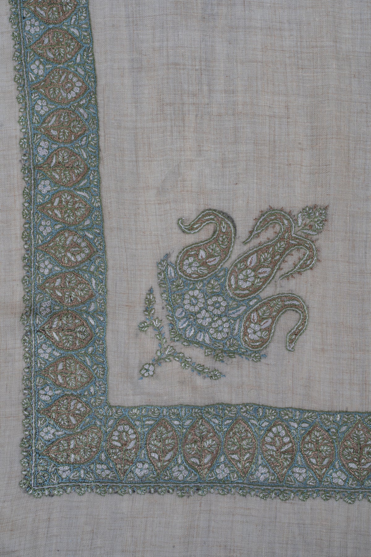 Beige rumal corner with a sage and aqua Sozni border and a matching three-paisley floral motif