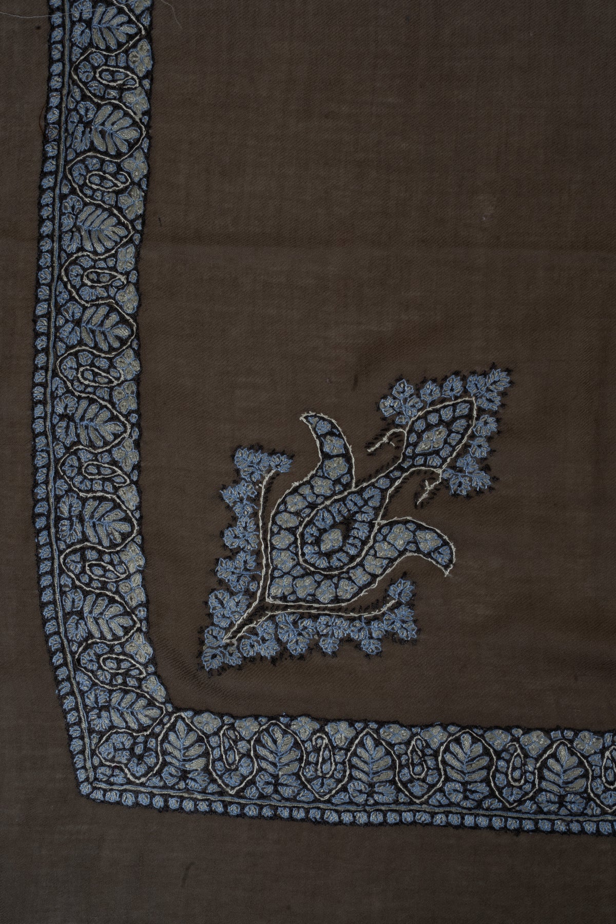 Mocha rumal corner with a pale blue Sozni floral border and a matching curled motif