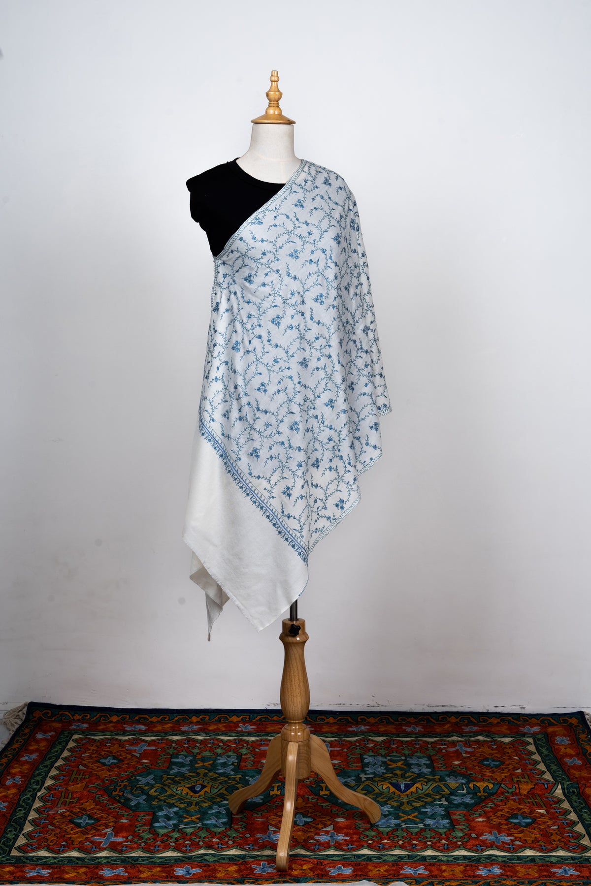 Full-length ivory stole shown at an angle on a mannequin, with blue floral vines and plain hanging end panels