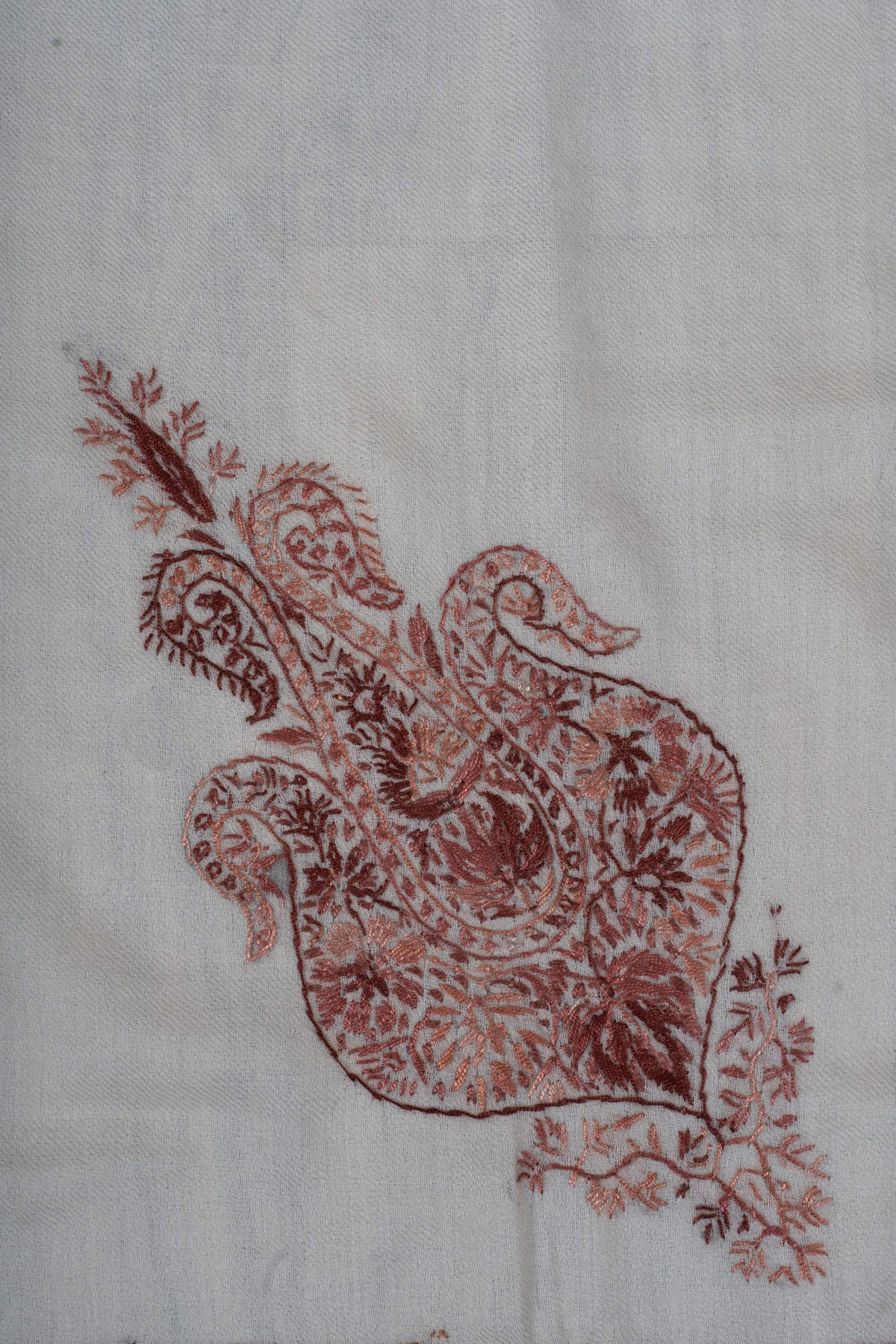 Close-up of the smaller dusty-rose motif filled with fine flowers, leaves and curled tips
