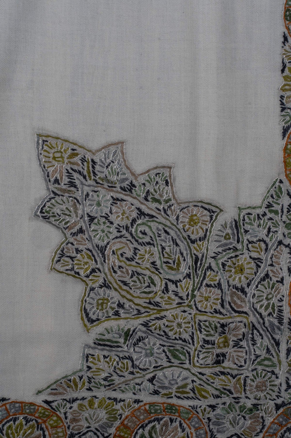 Close-up of a large pointed Sozni corner motif filled with olive and charcoal flowers and fine ivory outlines