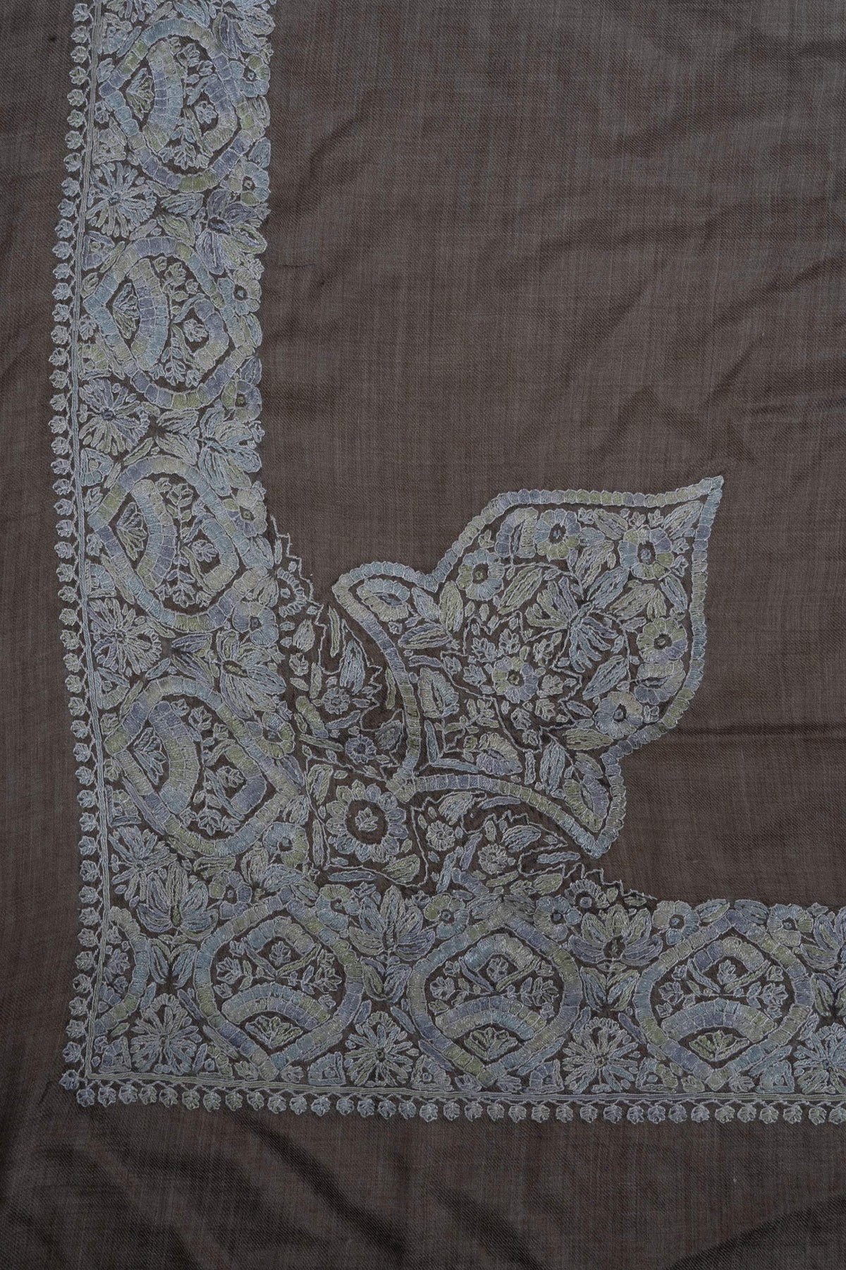 Taupe rumal corner with a large pale blue-grey Sozni floral panel connected to the broad border