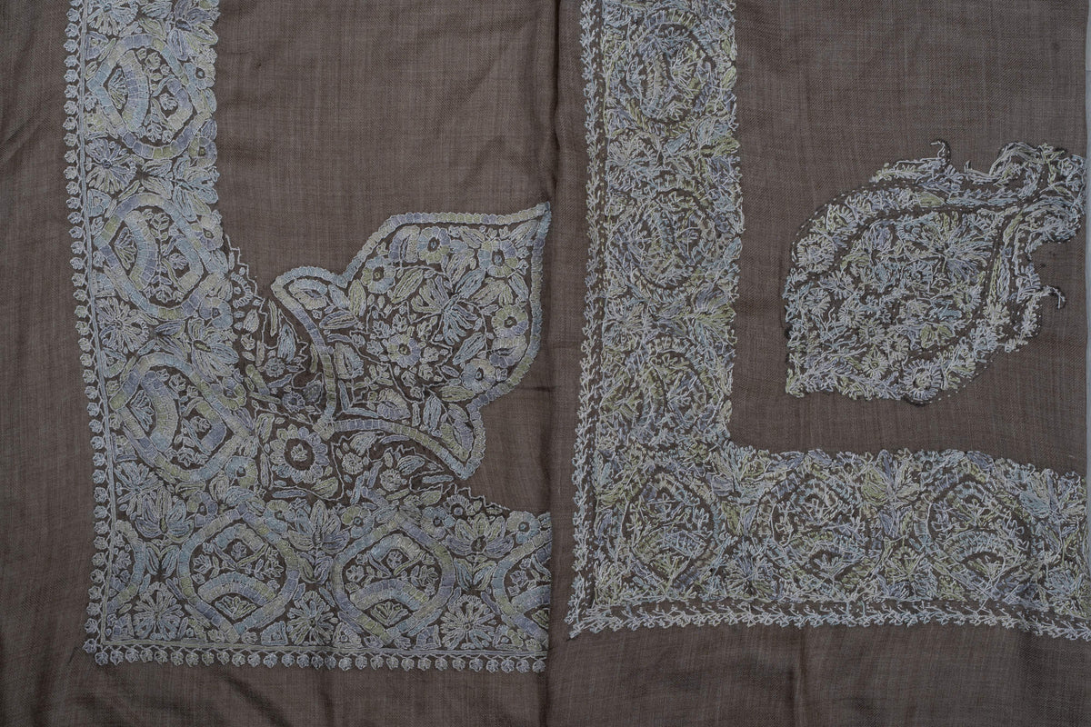 Folded taupe rumal showing both sides of pale blue-grey Sozni borders with a large corner panel and separate crest