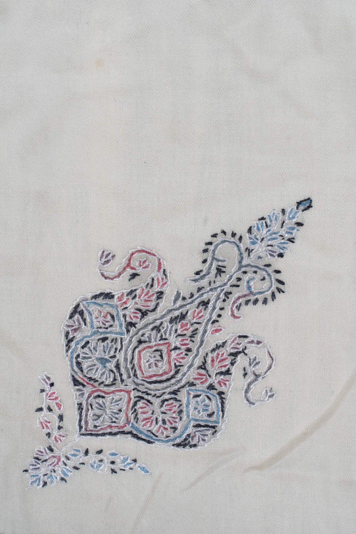Close-up of the smaller blue and pink ornamental motif with fine floral details