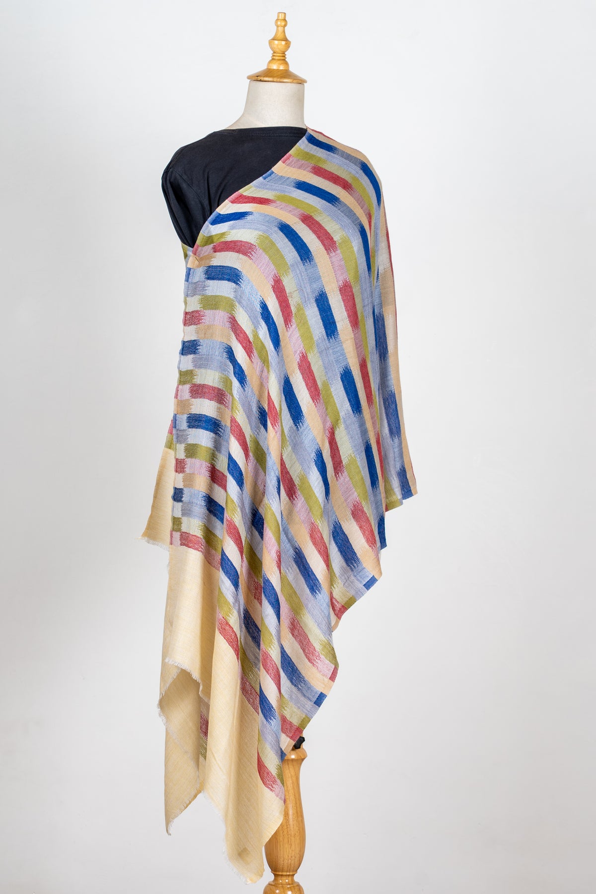 Full view of the cream stole on a mannequin, with blue, rose and olive brushstroke stripes falling in long folds