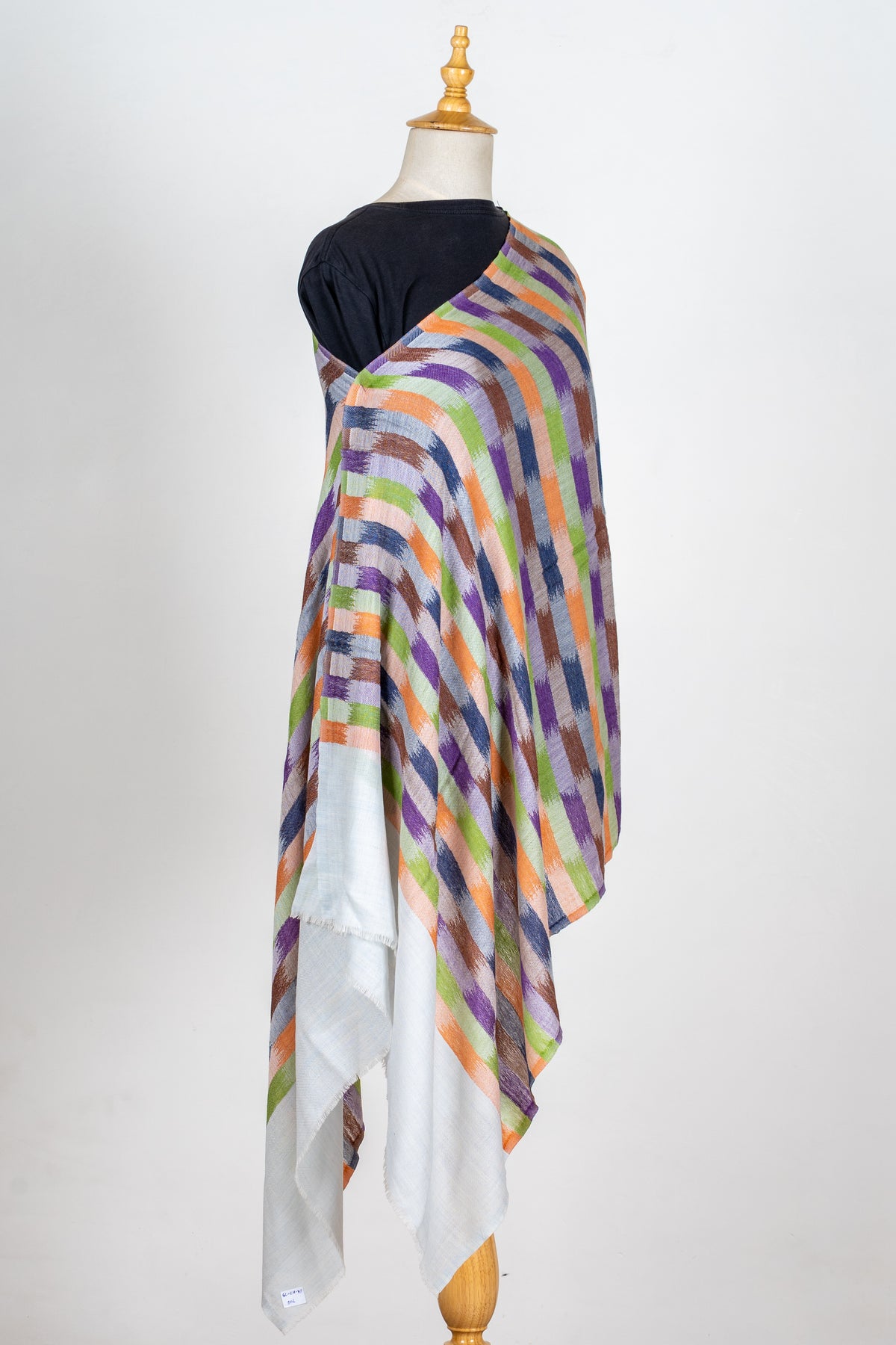Full-length printed Merino wool stole draped on a mannequin, with multicoloured geometric stripes and long pale end panels