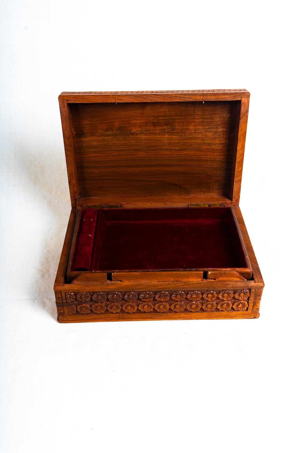 Open walnut jewellery box with a plain wooden lid interior and red velvet-lined tray
