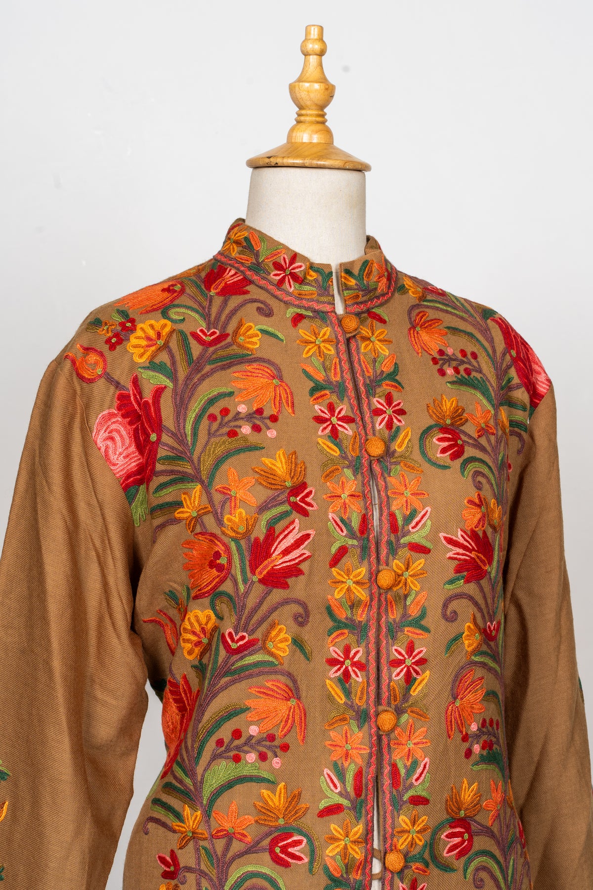 Upper front view of the earthy brown Hand Aari jacket, showing the band collar and multicoloured floral embroidery