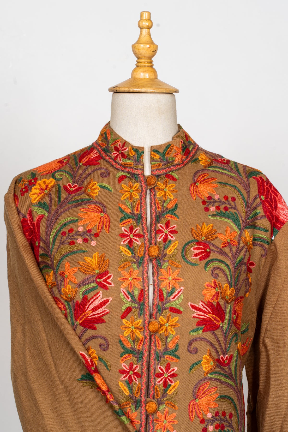 Close-up of the earthy brown Hand Aari jacket’s band collar, shoulders and embroidered upper front