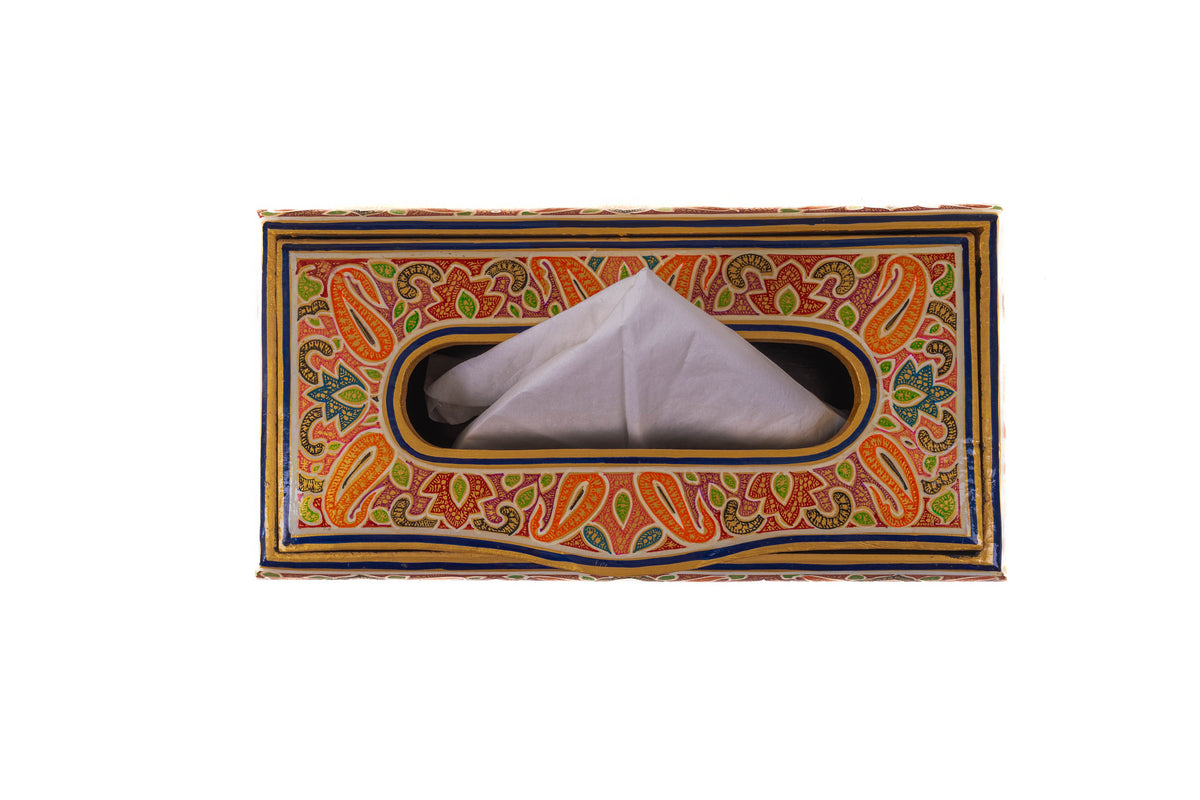 Top view of a rectangular orange-and-green paisley tissue box with a white tissue folded through its oval slot