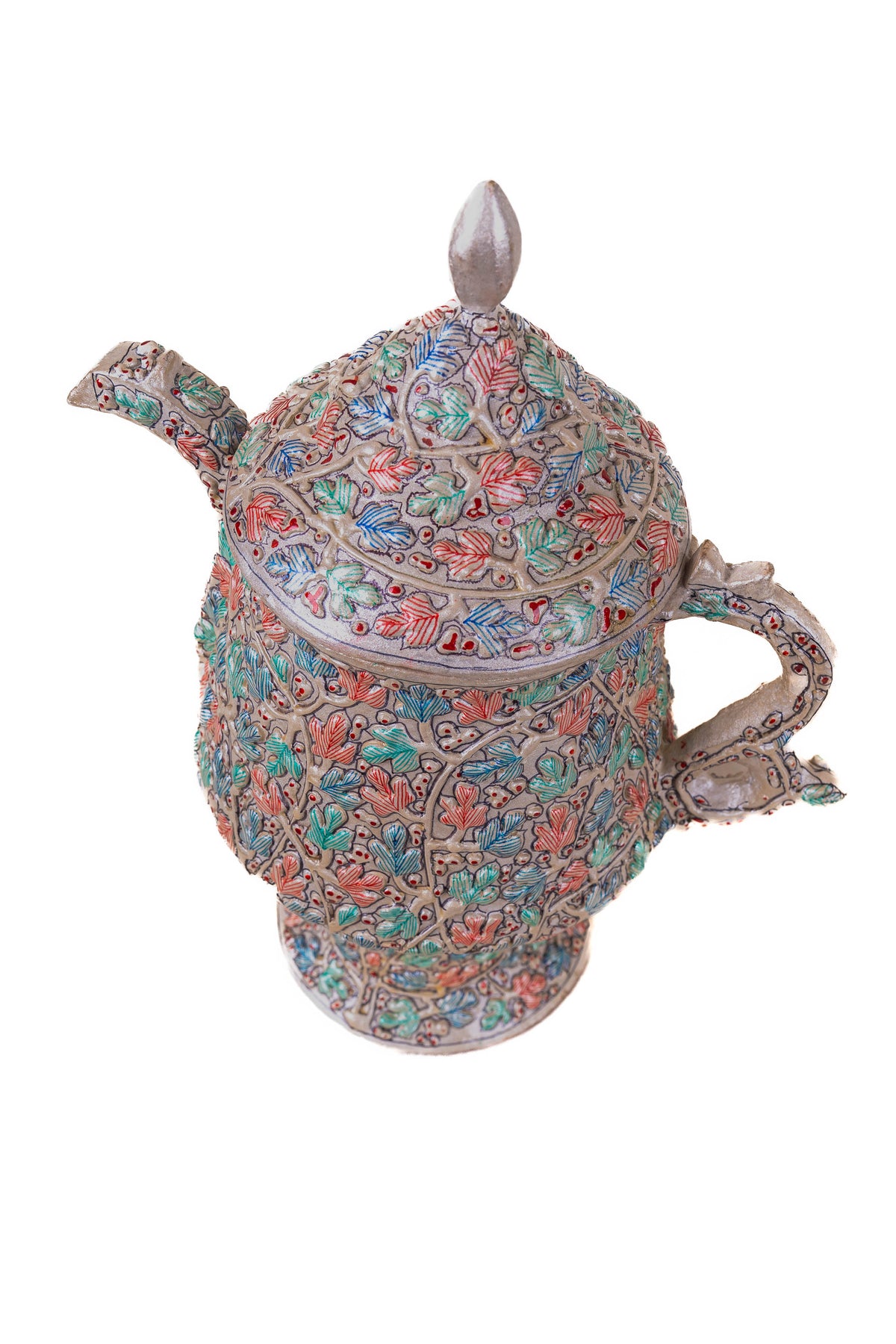 Angled view of the painted teapot showing its short spout, curved handle, pointed lid finial and flared foot.
