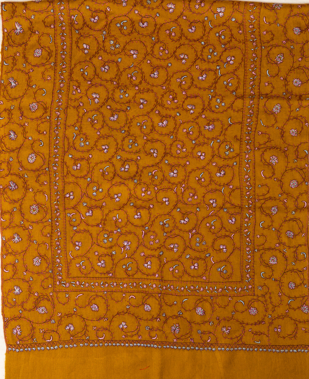 Mustard stole laid flat with pink and white Sozni floral vines and a narrow border framing the centre