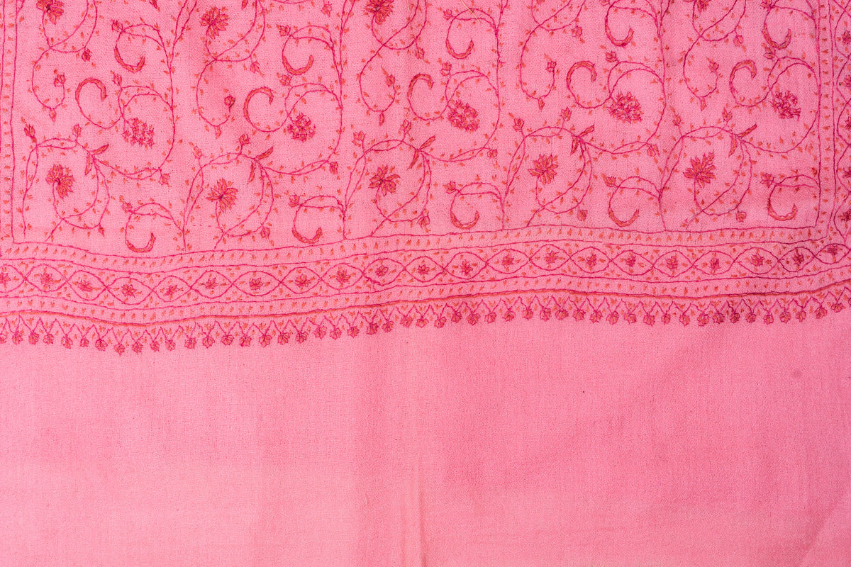 Pink stole laid flat, showing tonal floral vines above an embroidered end border and plain pink panel