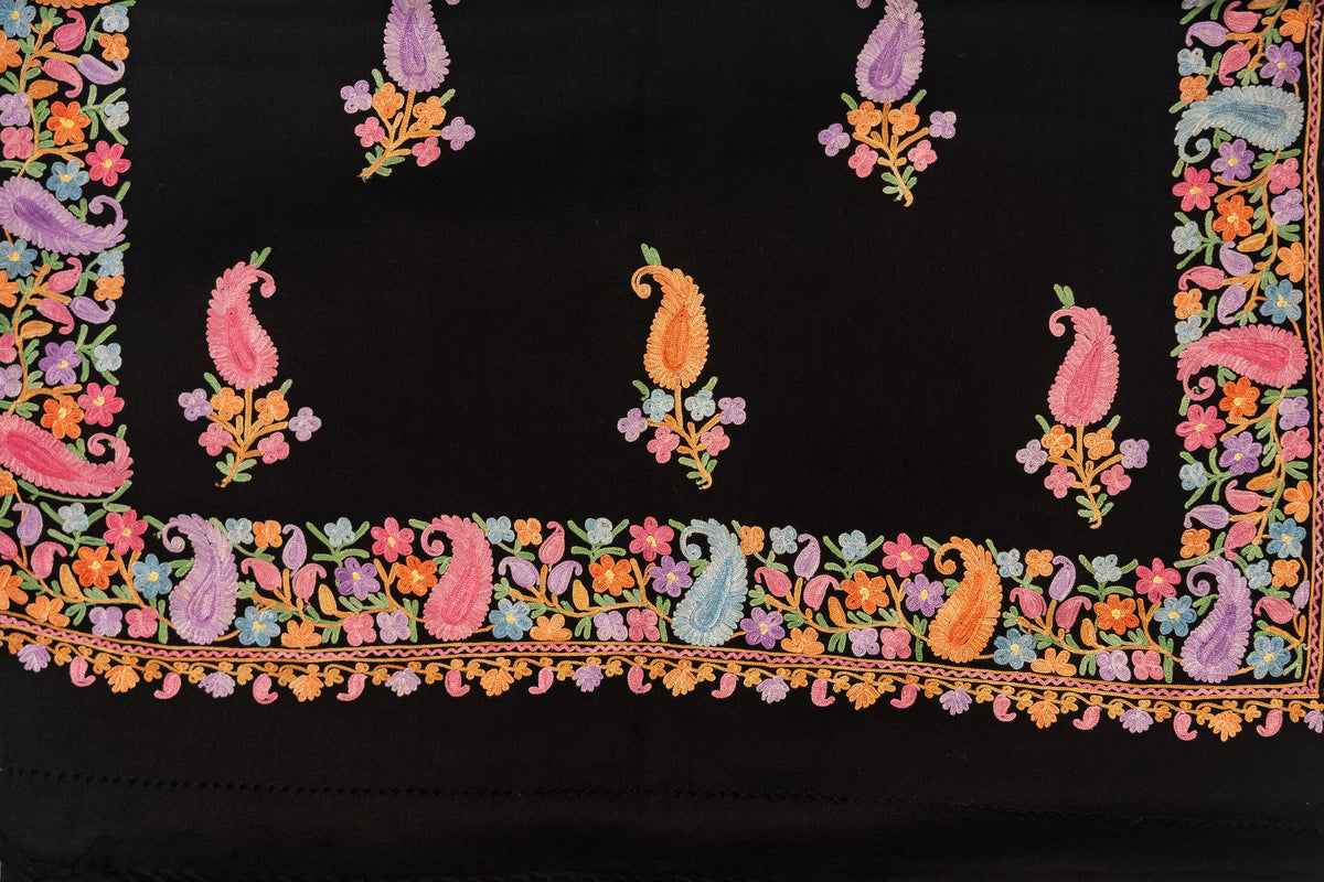 Black stole spread flat, showing scattered multicoloured paisley sprigs within a dense floral and paisley border.