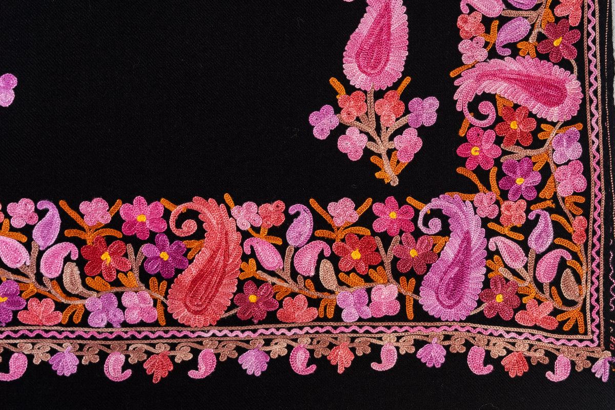 Flat corner detail of pink and magenta Aari paisleys and flowers along the black stole’s border