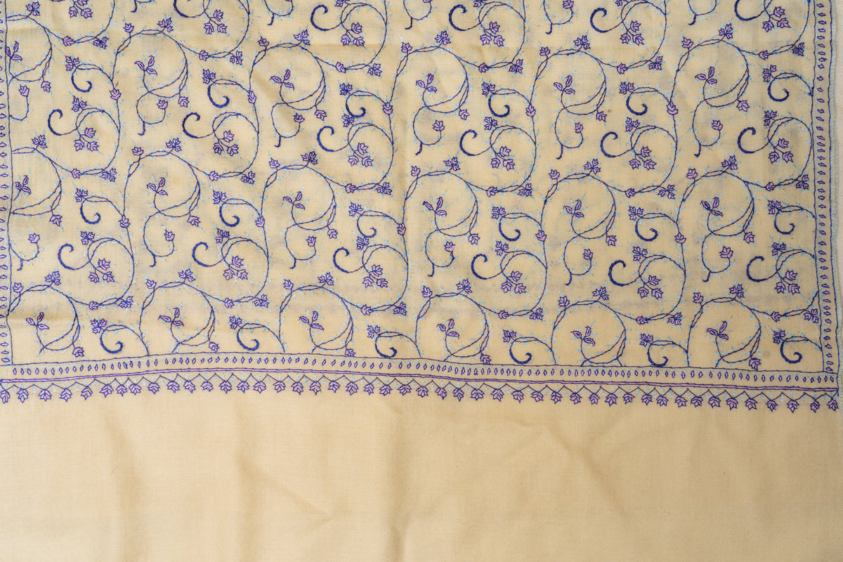 Cream stole laid flat with purple floral vines above a narrow border and broad plain end panel