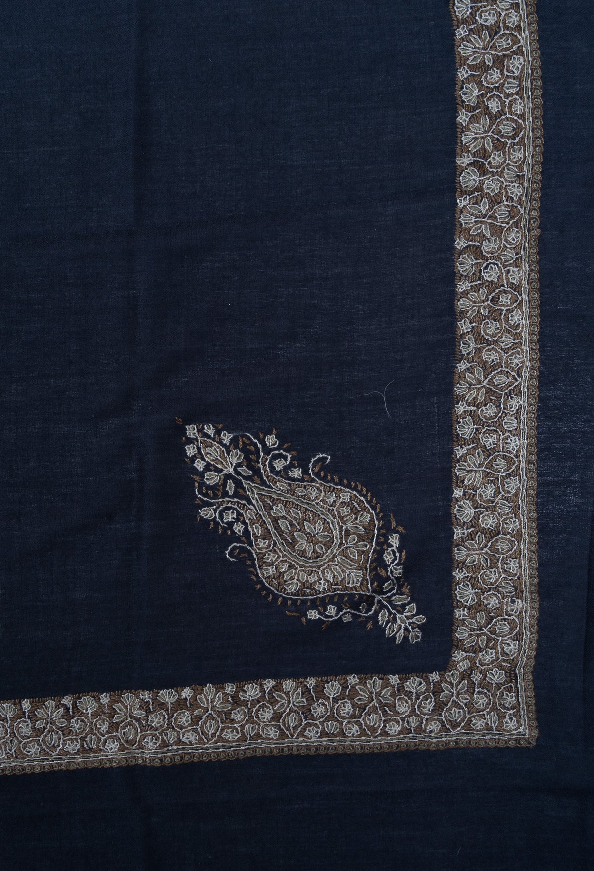 Corner of a navy rumal showing a gold and ivory floral paisley inside intersecting Sozni borders