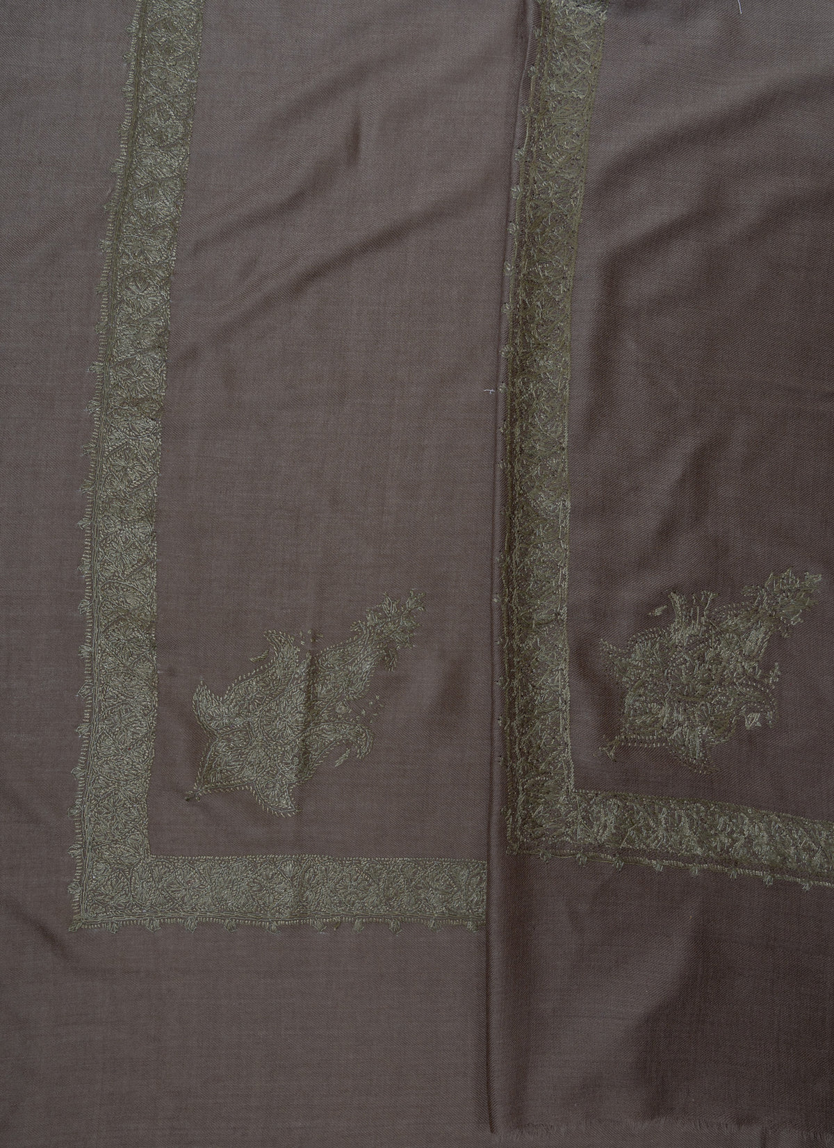 Overlapping taupe-grey rumal corners, showing both sides of sage-green Sozni floral motifs and borders