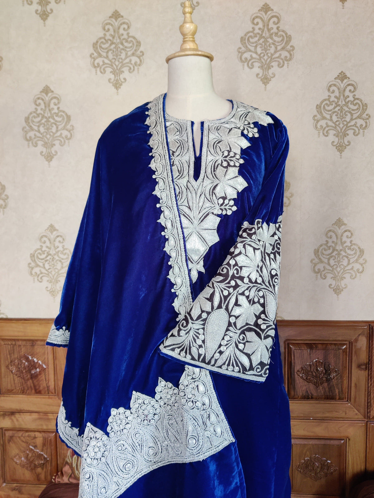 Closer front view of the blue velvet pheran and stole, highlighting the embroidered neckline, wide cuff and paisley stole border.