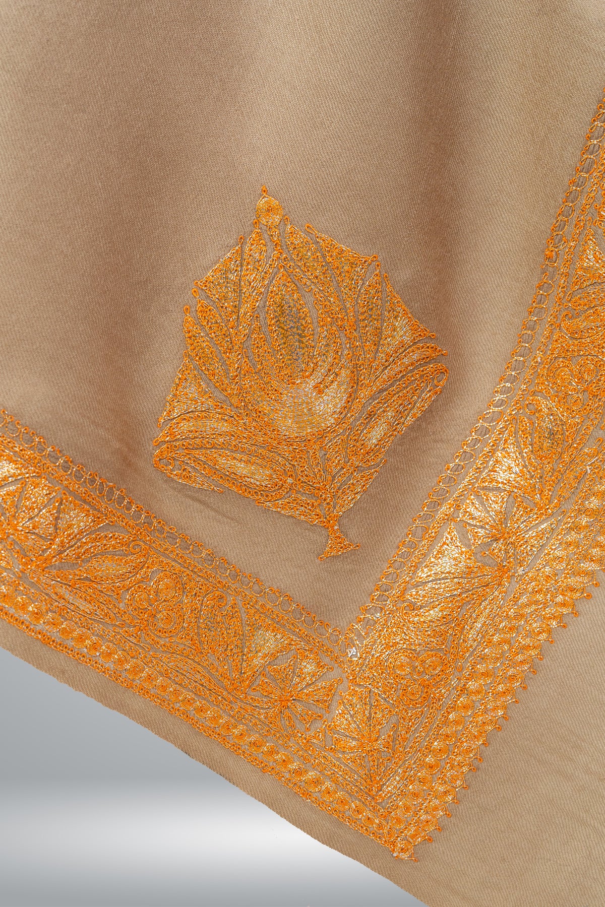 Beige shawl corner with a golden-orange Tilla leaf motif and a broad embroidered border with delicate looped edging