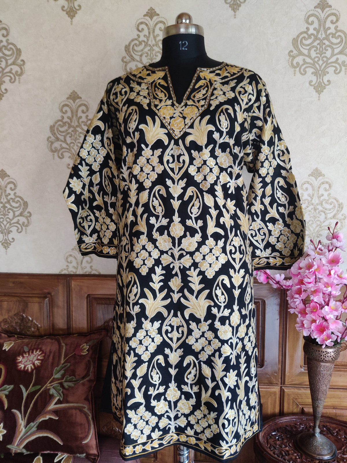 Full front view of a black pheran with pale-gold floral vines, a slit neckline and wide sleeves.
