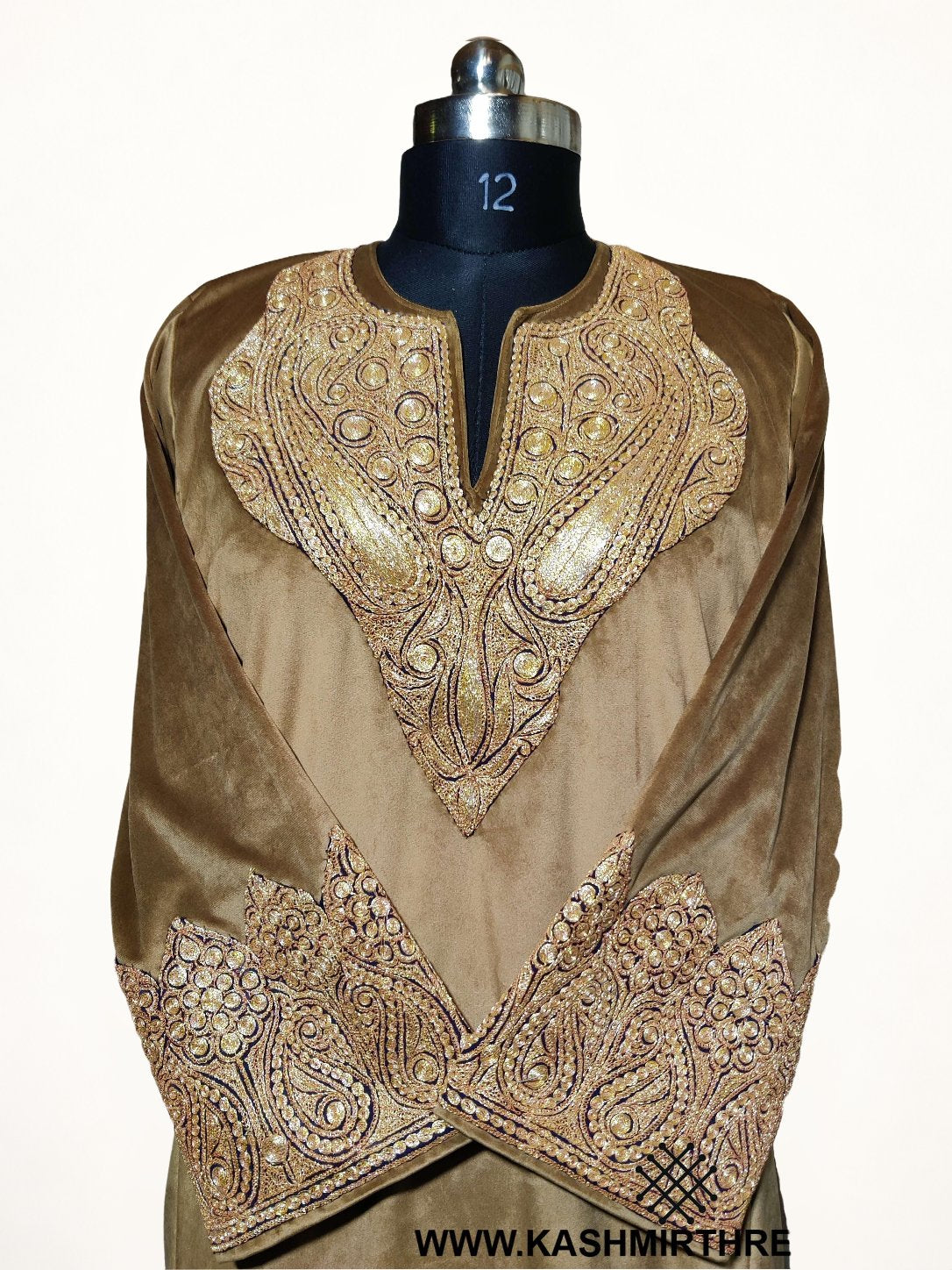 Front detail of a brown velvet pheran on a mannequin, with gold-toned Tilla paisleys around the neckline and on the crossed cuffs.