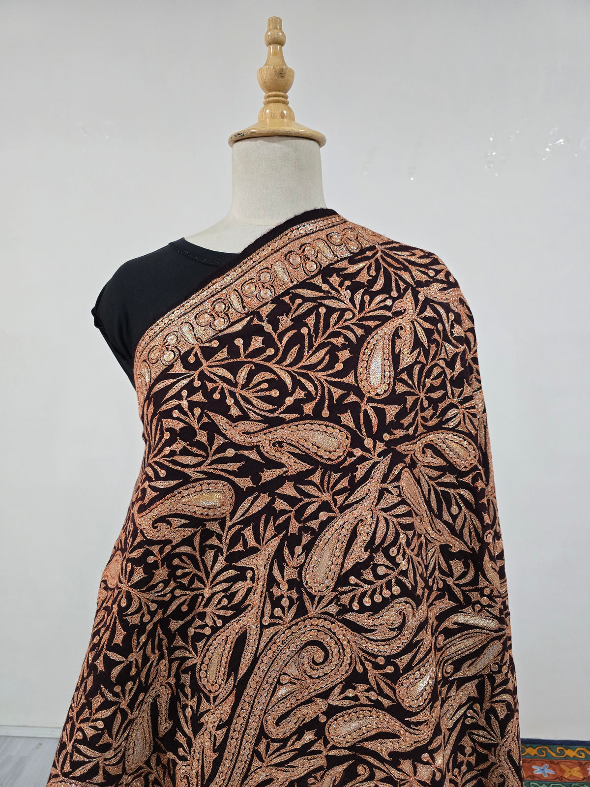 Front detail of the brown shawl showing dense copper-gold Tilla paisleys and fine branching leaves across the chest.