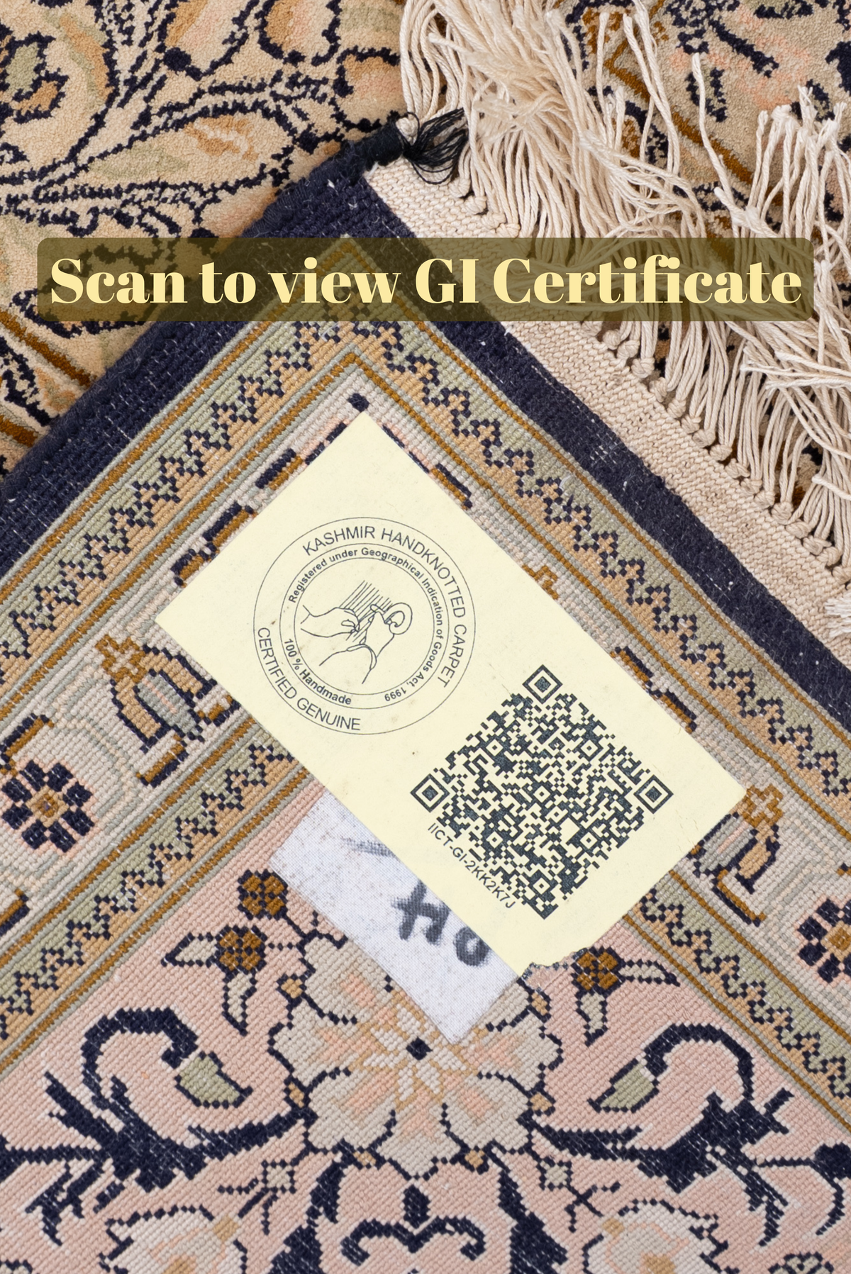GI certificate QR label on a folded ivory carpet corner beside pale fringe, with Scan to view GI Certificate text