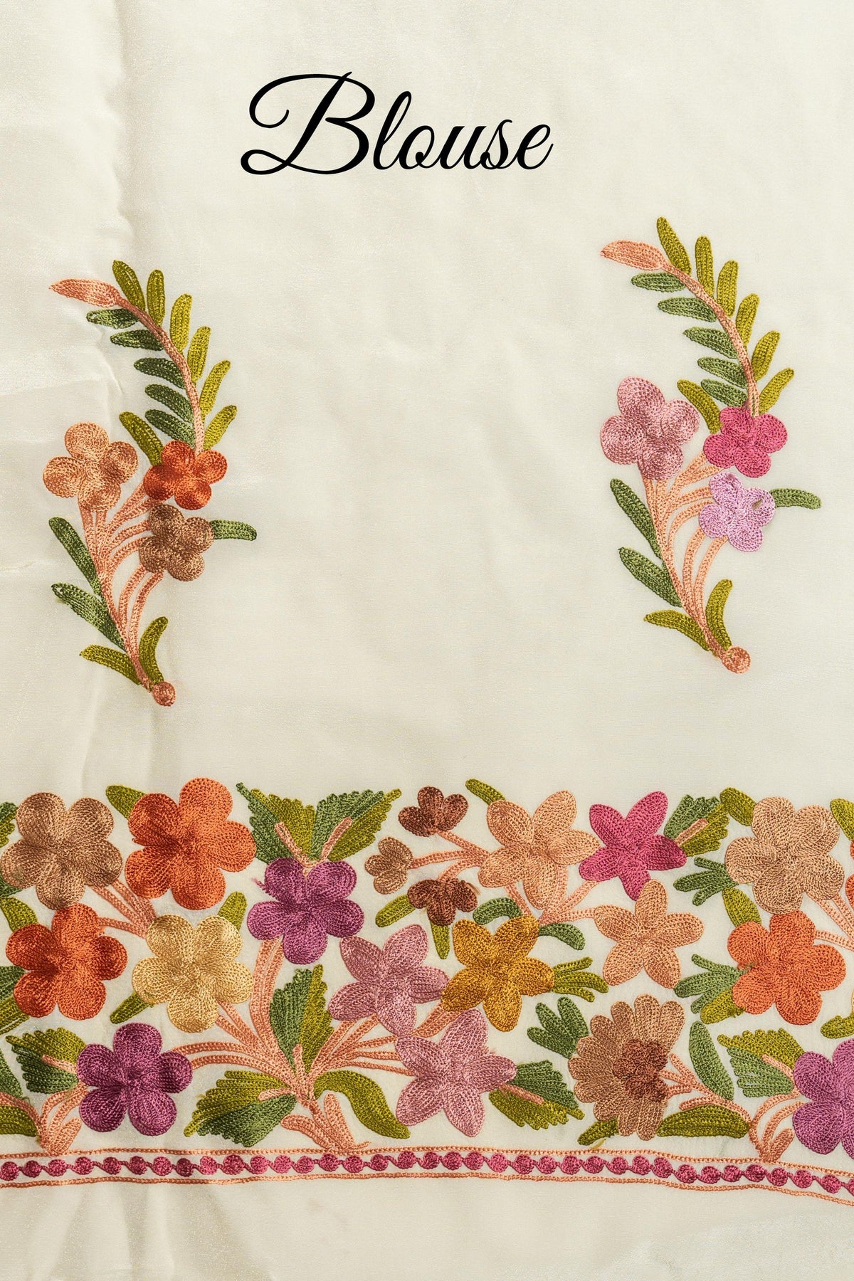 Cream fabric labelled “Blouse”, showing two embroidered floral sprigs above a broad multicoloured flower border.