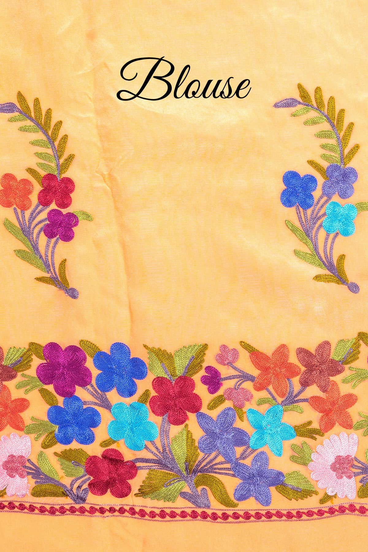 Light-orange fabric labelled “Blouse”, showing two floral sprigs above a bright blue, purple, coral and turquoise flower border.