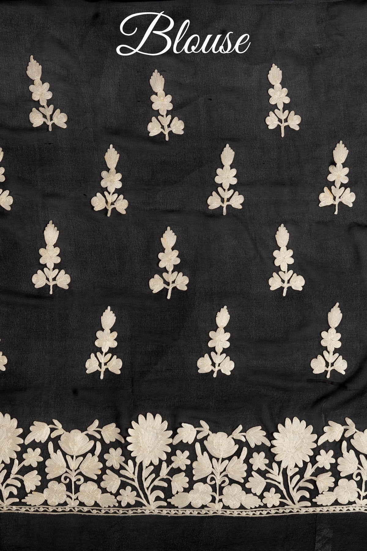 Black blouse fabric with scattered cream Aari flower sprigs and a floral border, labelled “Blouse” above.