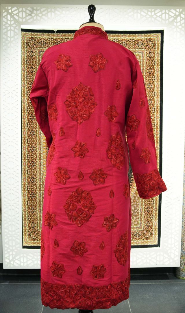 Back of the ruby-red jacket with scattered tonal Aari floral medallions, small paisleys and dense embroidered cuffs and hem.
