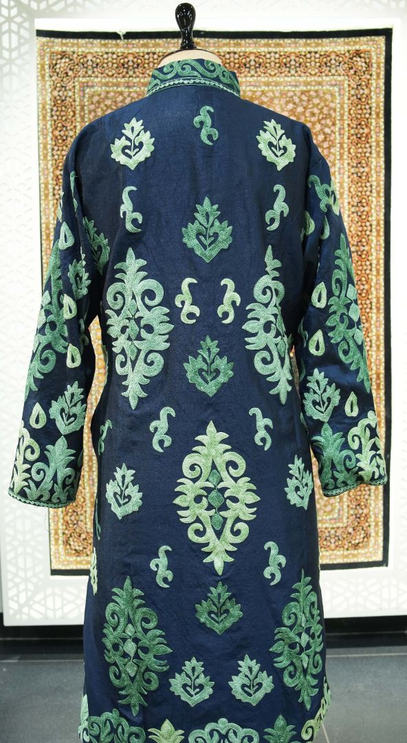 Back of the navy long jacket with green leaf-shaped medallions, small scrolls and embroidered sleeves