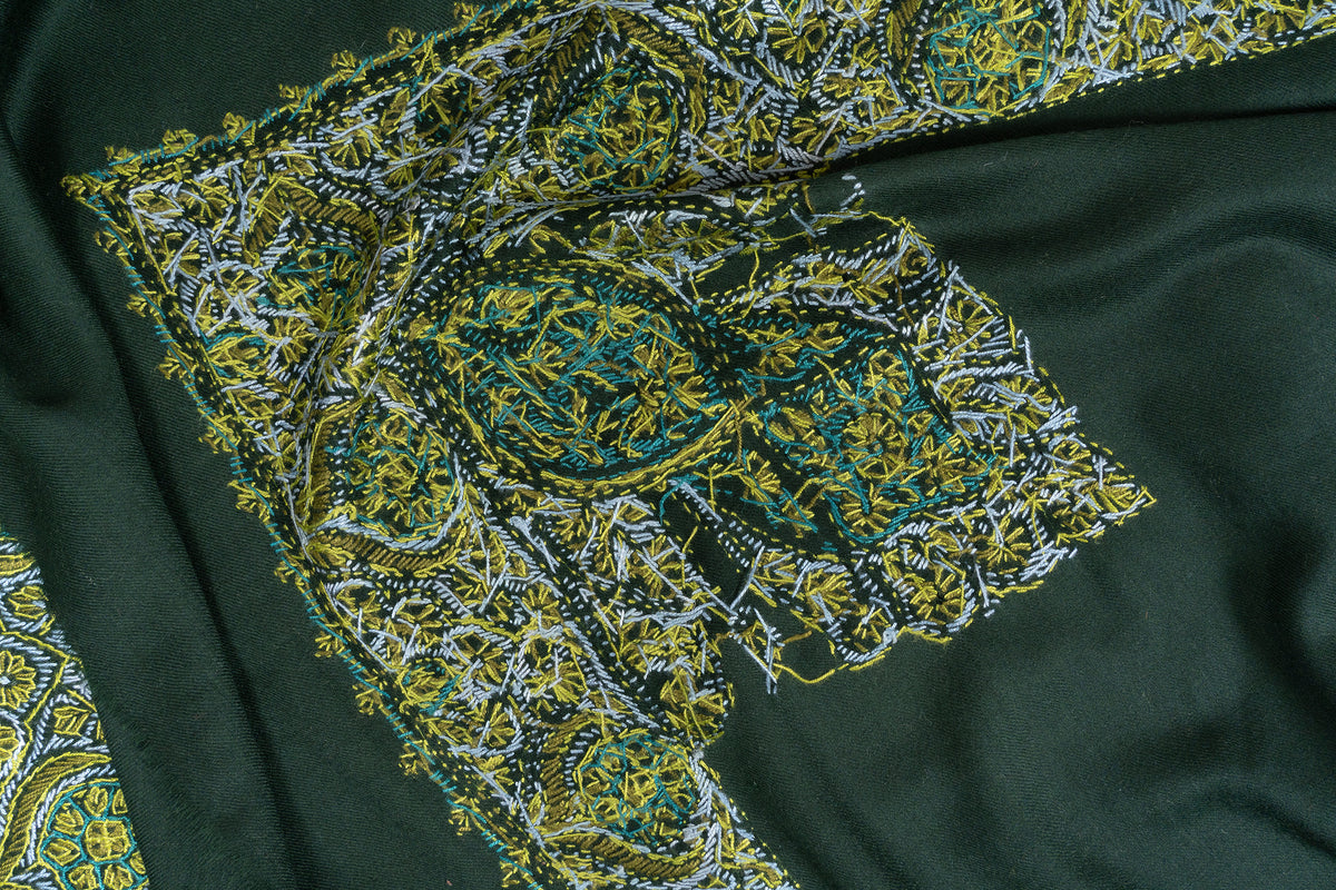 Close view of the reverse stitching behind a large corner motif and border on the emerald green rumal