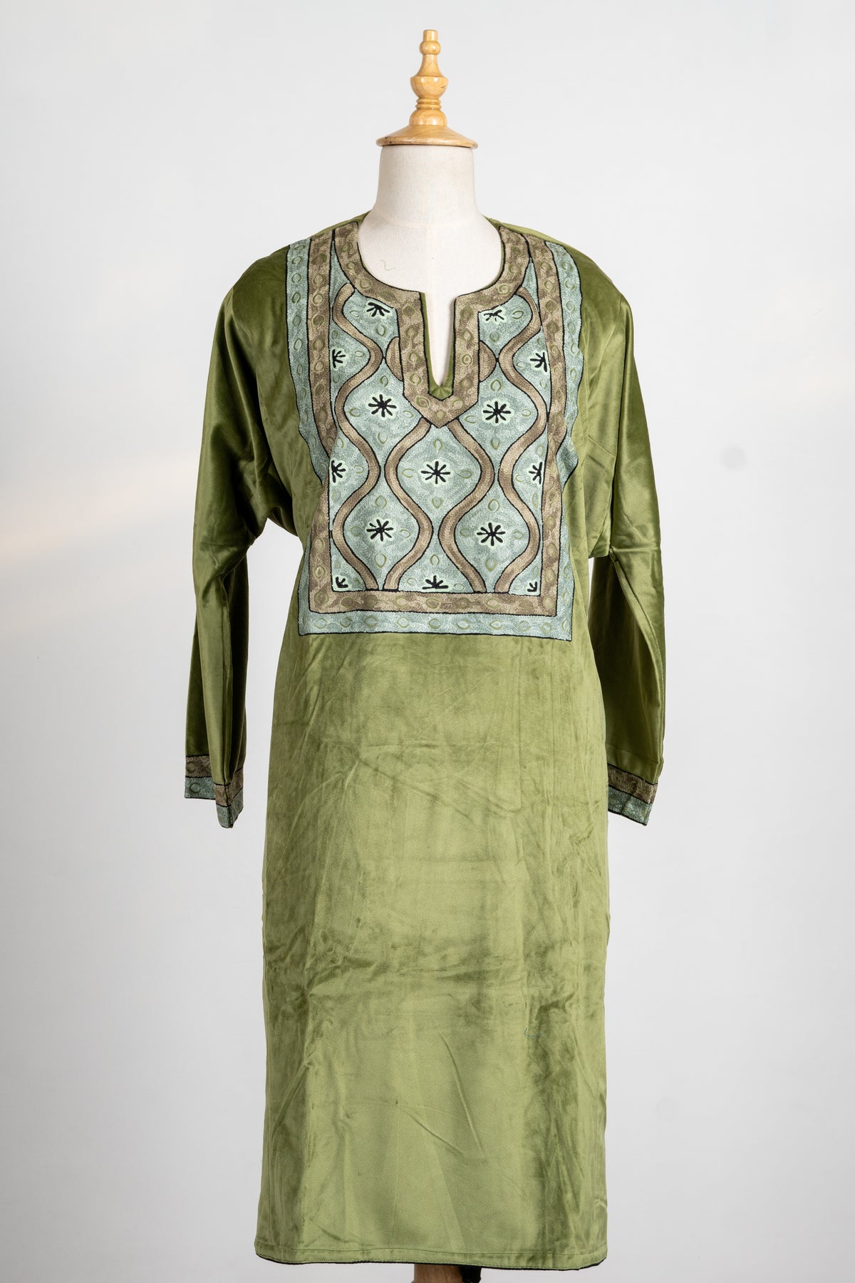 Front view of the olive velvet tunic without the stole, showing its embroidered chest panel and narrow cuff borders.