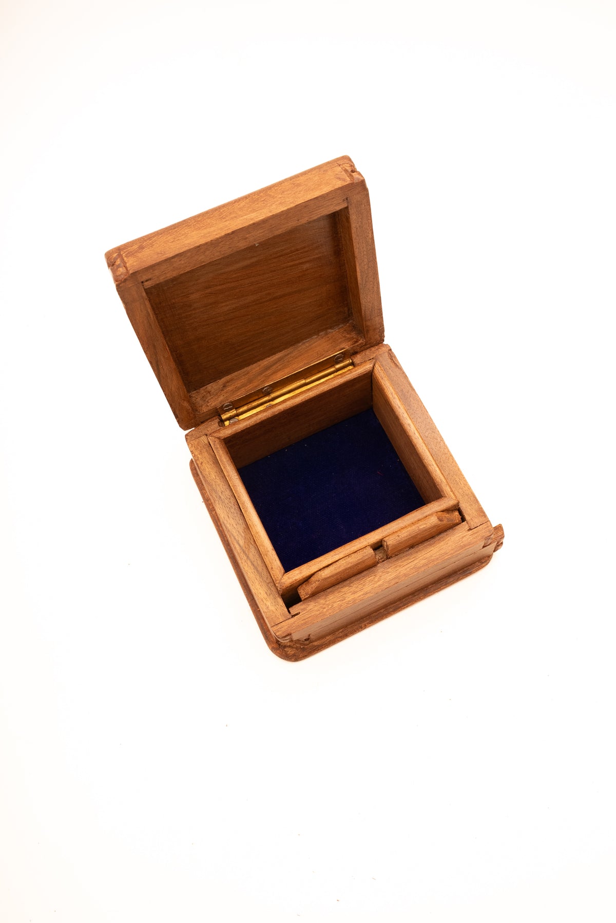 Angled overhead view of the open walnut wood box with a dark blue-lined compartment