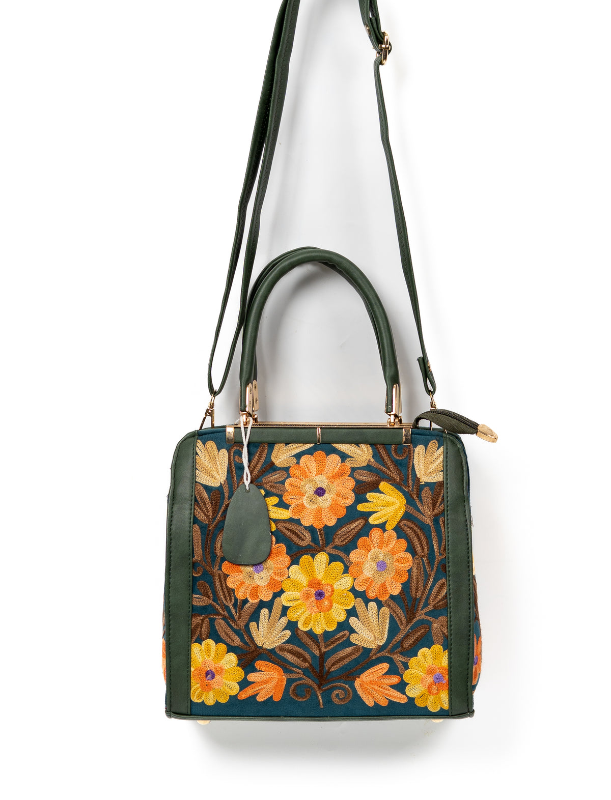 Dark green floral handbag hanging from its long shoulder strap, with double handles and orange and yellow Aari flowers