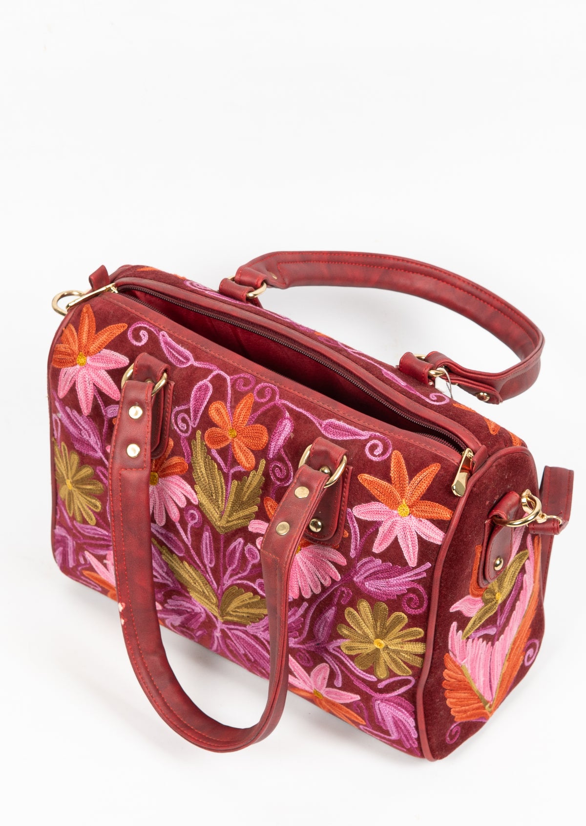 Top angled view of the maroon floral handbag, with lowered handles, a zip opening and gold-toned strap clips